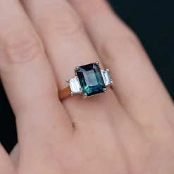 18ct Yellow and White Gold Teal/Parti Sapphire and Tapered Baguette Diamond 3 Stone Ring